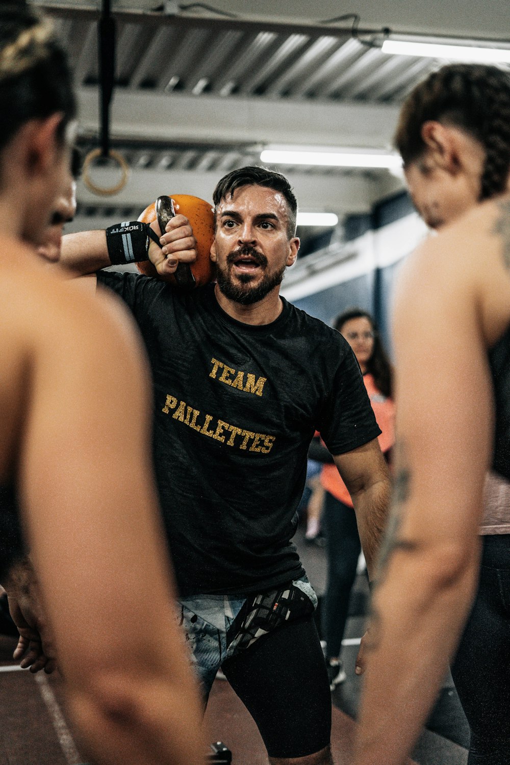 a man holding a frisbee in a gym