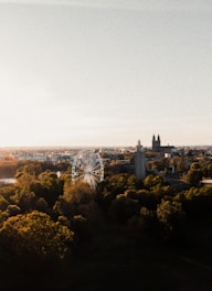 an aerial view of a city with a ferris wheel