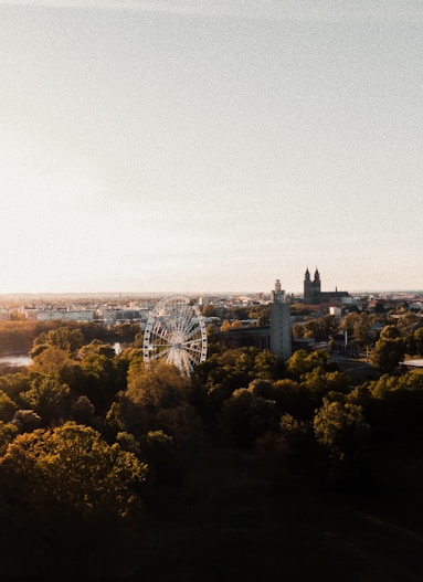 an aerial view of a city with a ferris wheel