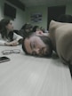 a man laying on a table with his head on the table