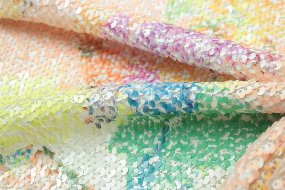 a close up of a colorful sequin fabric