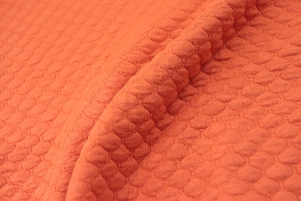 a close up view of an orange blanket