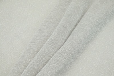Close-up of neatly folded premium fabric textures in neutral tones.