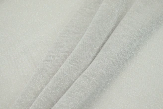 Close-up of textured fabric on a pair of relaxed-fit joggers in soft grey.