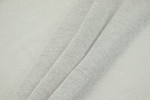 Close-up of textured sand-colored fabric with gentle folds.