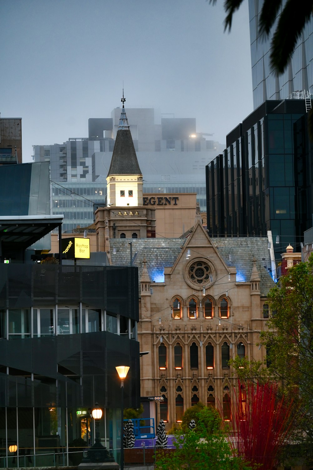 a large building with a clock tower in the middle of a city