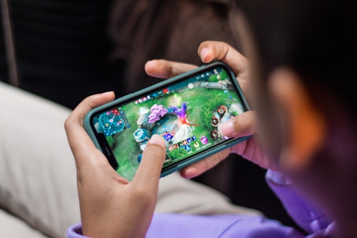 a person is playing a video game on their phone