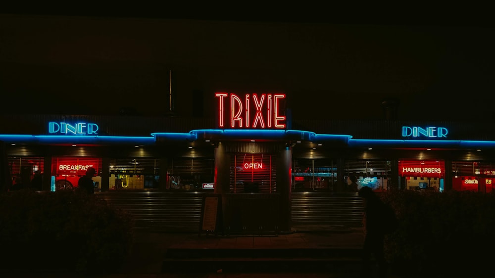 a neon sign that says taxie on the side of a building