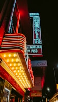 Late night scene outside Pizza Route 88 with glowing red and yellow neon signs.