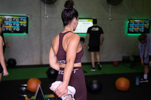 a woman in a sports bra top and leggings in a gym
