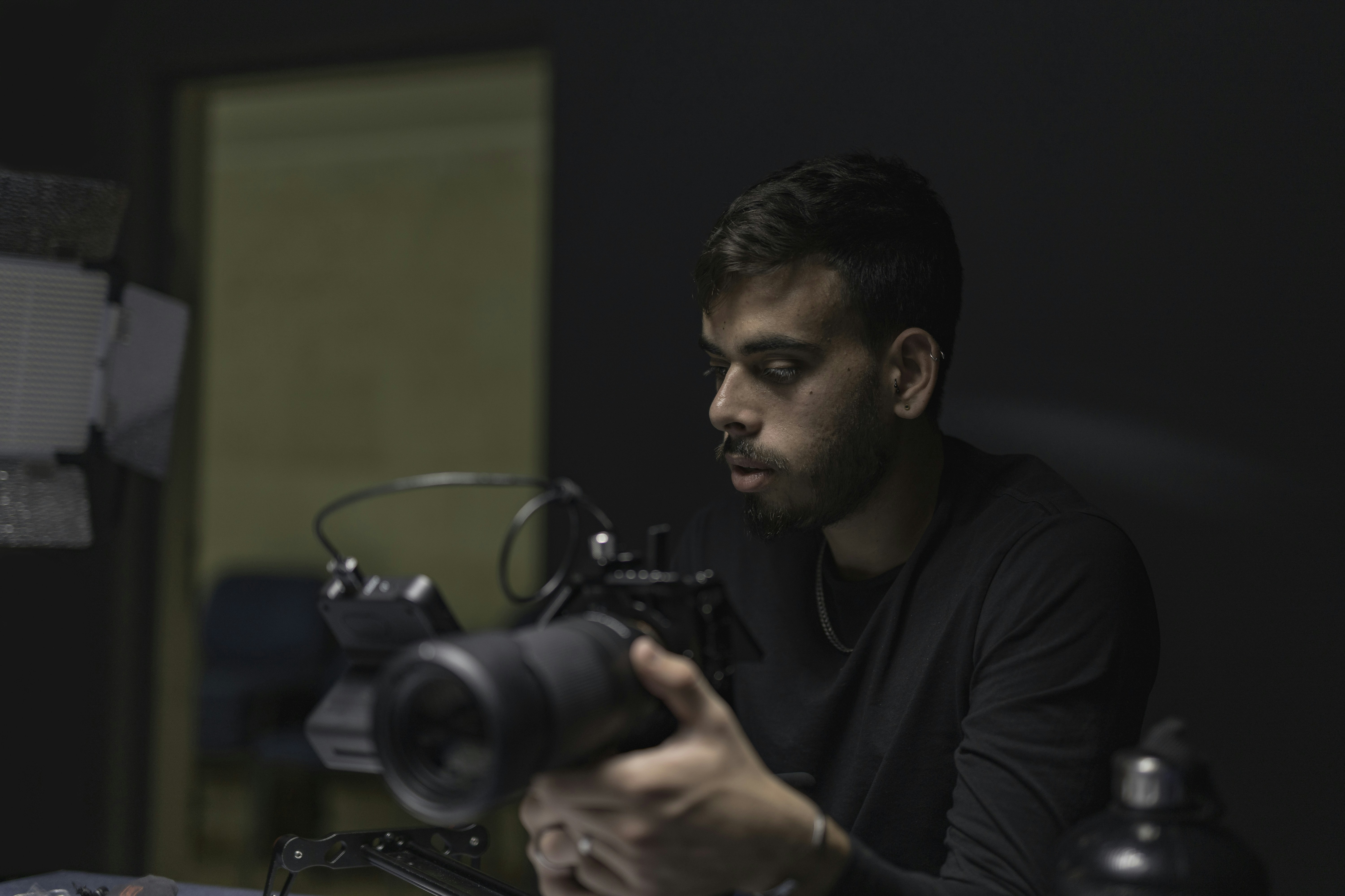 a man sitting at a table with a camera