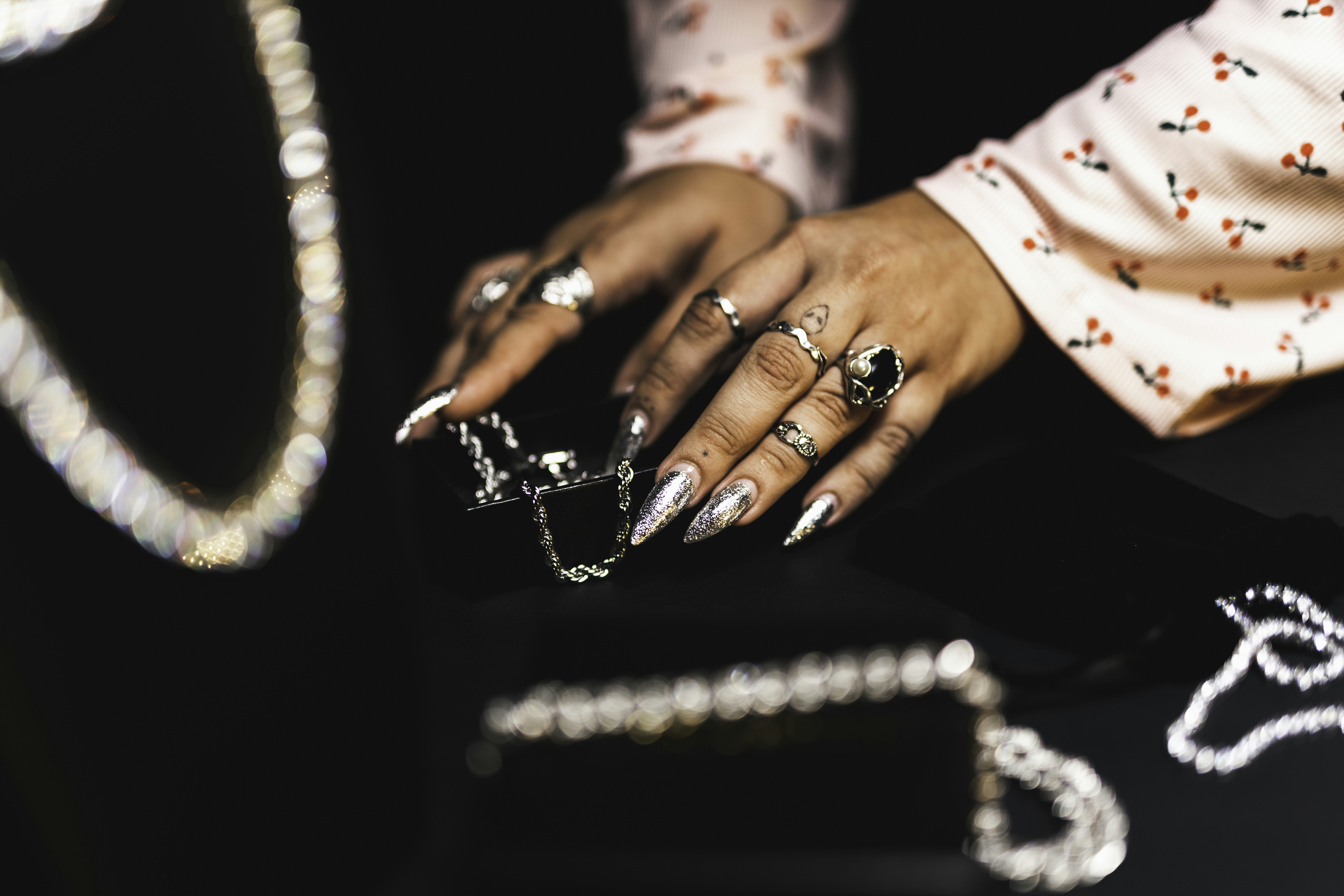 a close up of a person's hands with rings