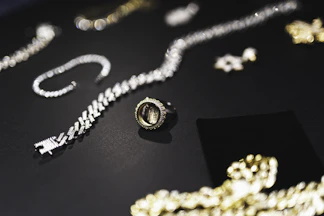 a table topped with lots of different types of jewelry