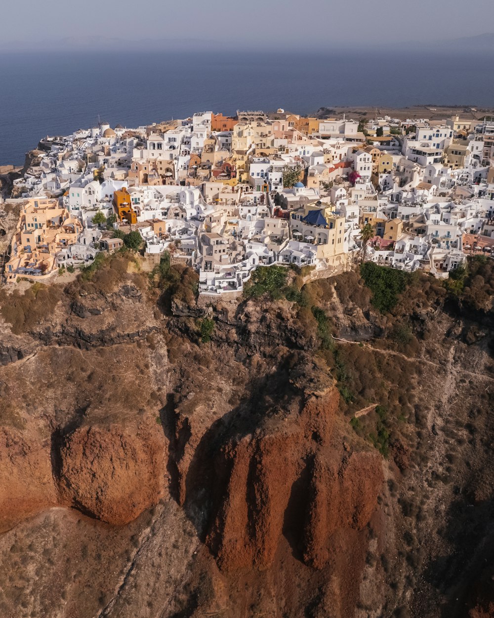 a view of a city on a cliff near the ocean