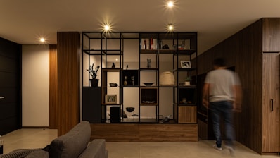 a man is walking through a living room