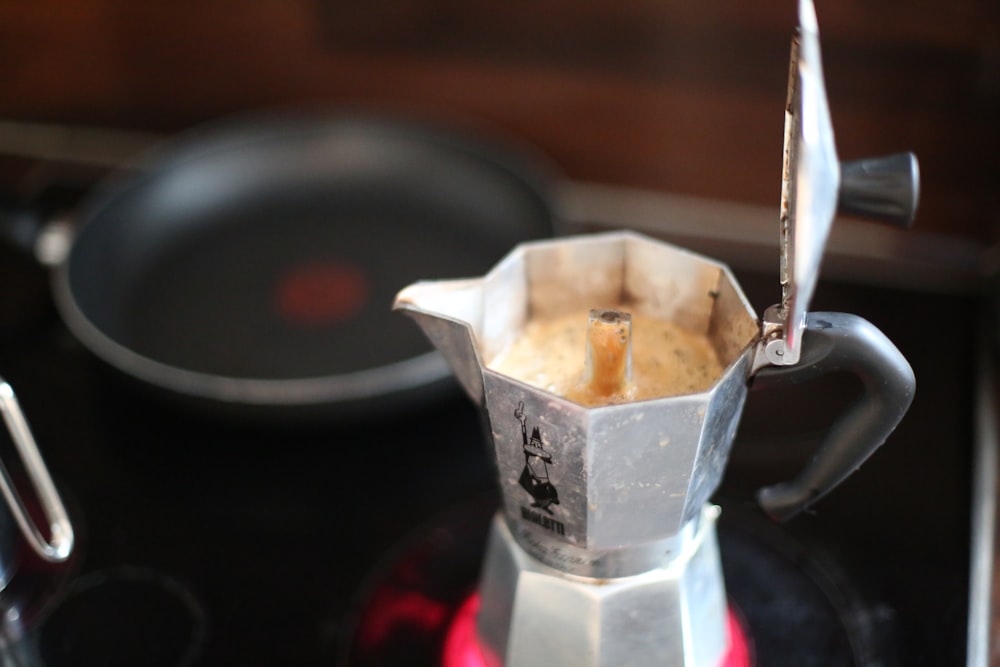 a stove top with a blender on top of it