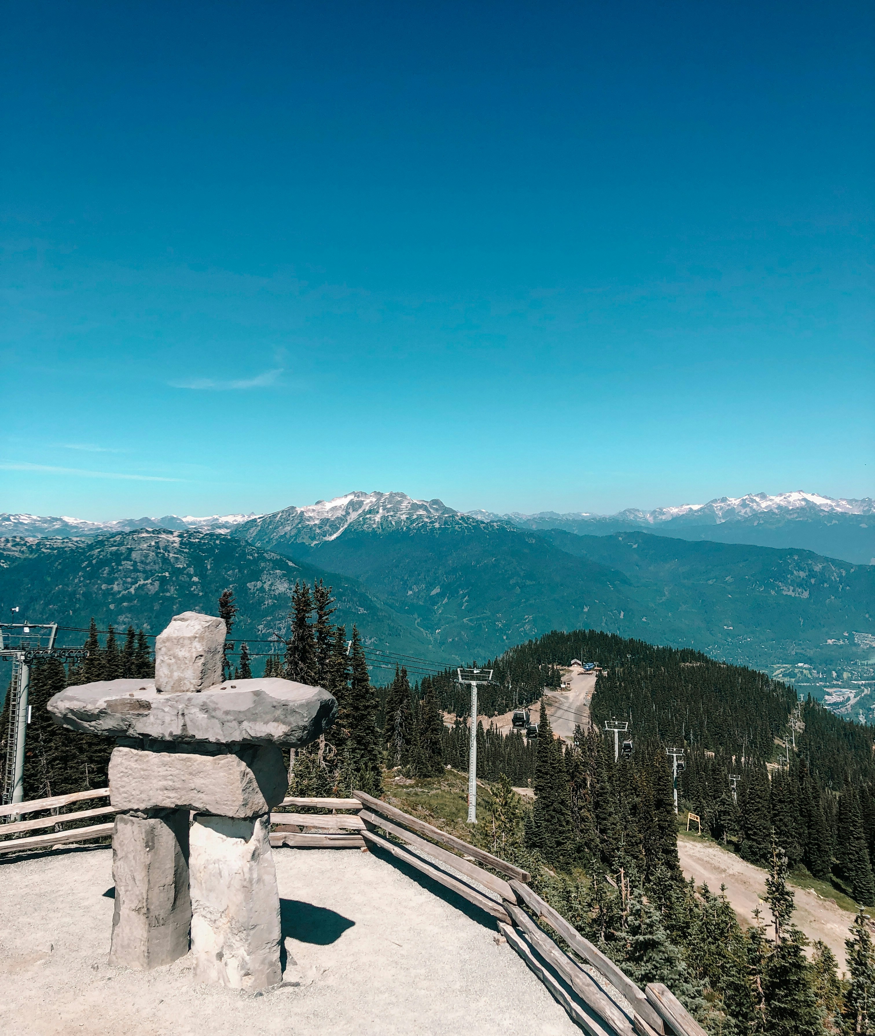 a stone bench sitting on top of a mountain