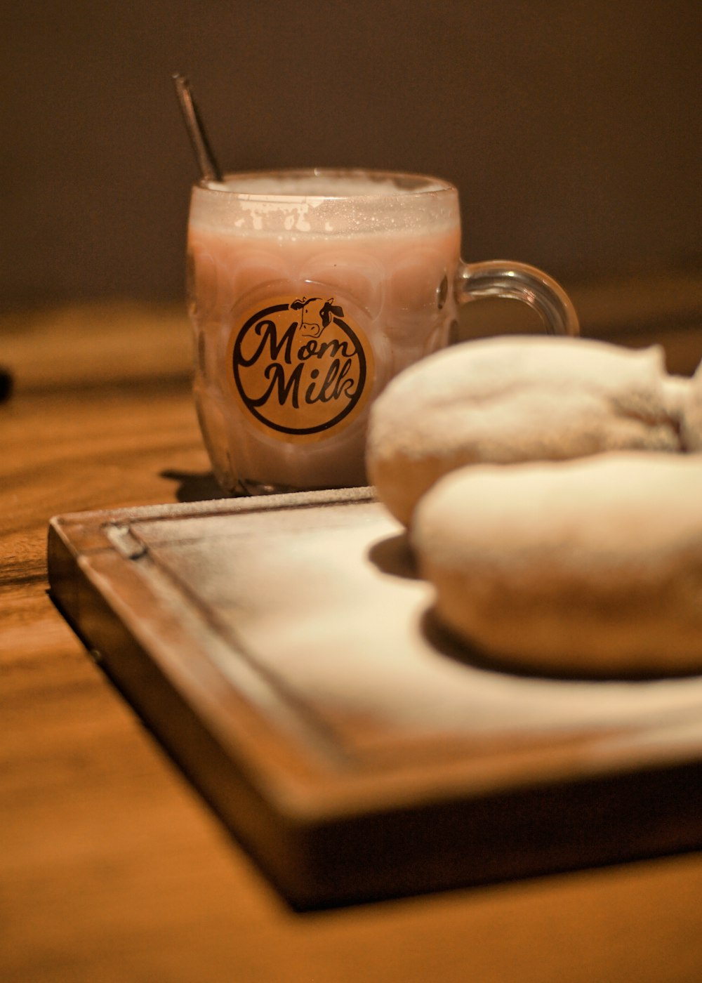 a couple of doughnuts sitting on top of a wooden table