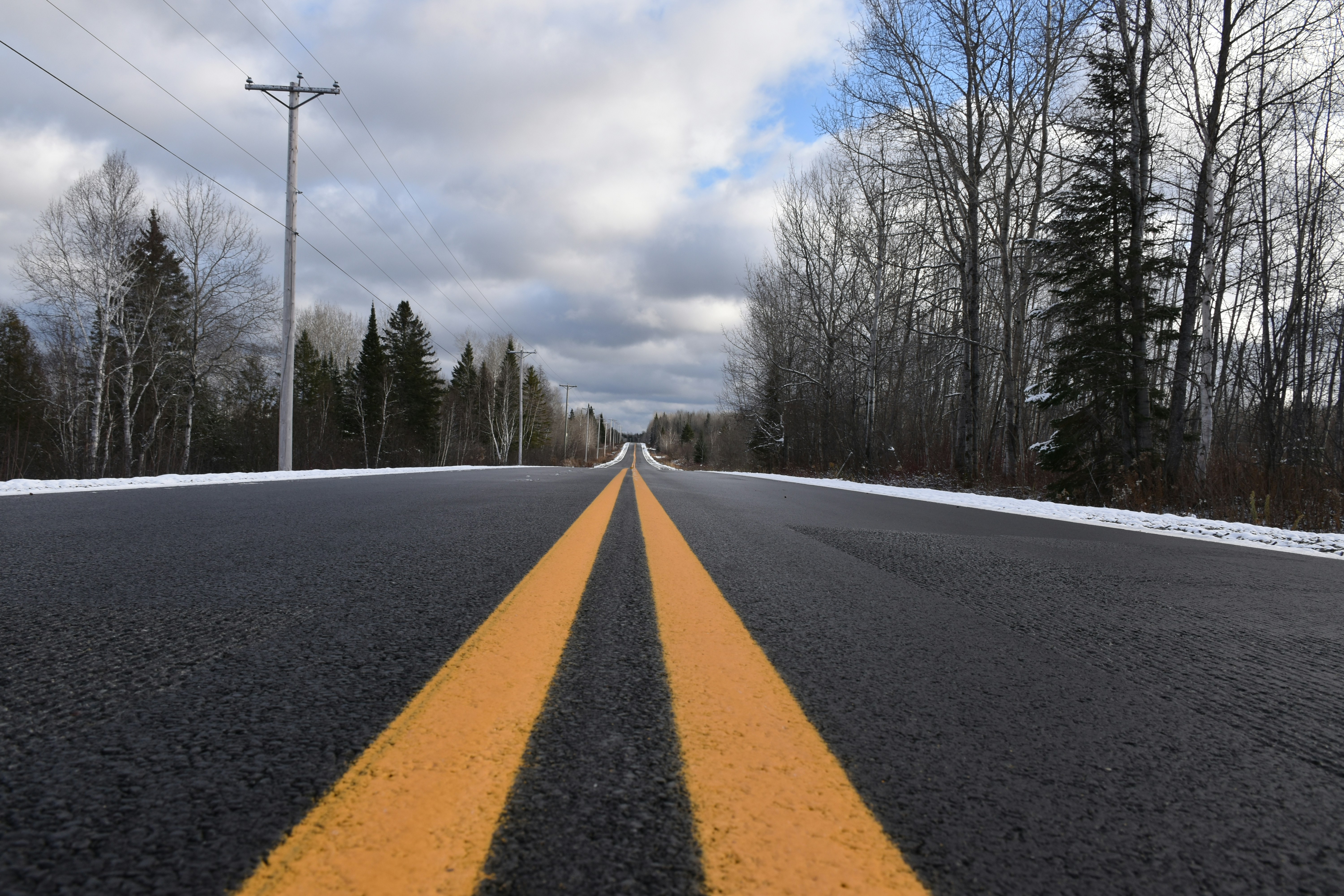 A road with two yellow lines on the side of it photo – Free Forest ...