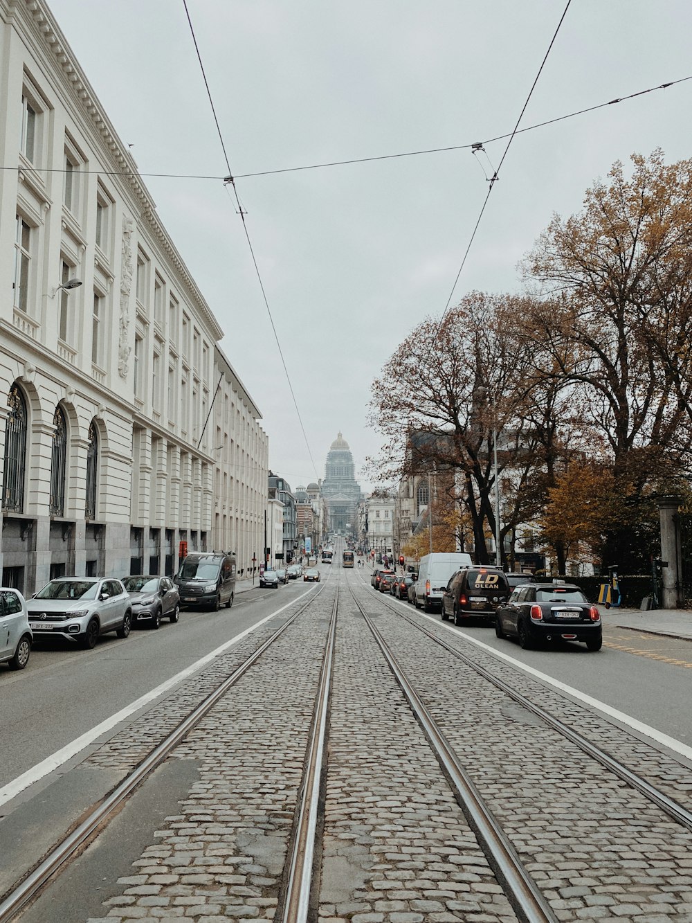 a city street with cars parked on the side of the road