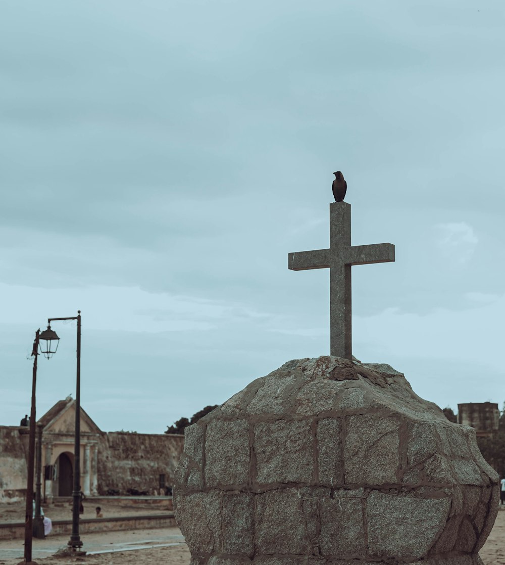 a large rock with a cross on top of it