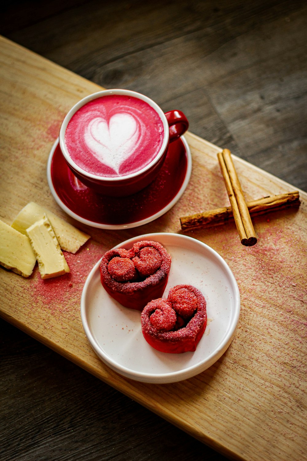 a cup of coffee and some cinnamons on a table