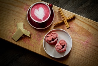 a cup of coffee and some cinnamons on a table