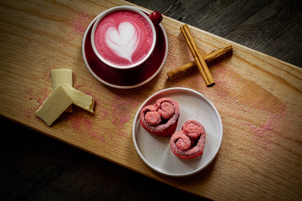 a cup of coffee and some cinnamons on a table