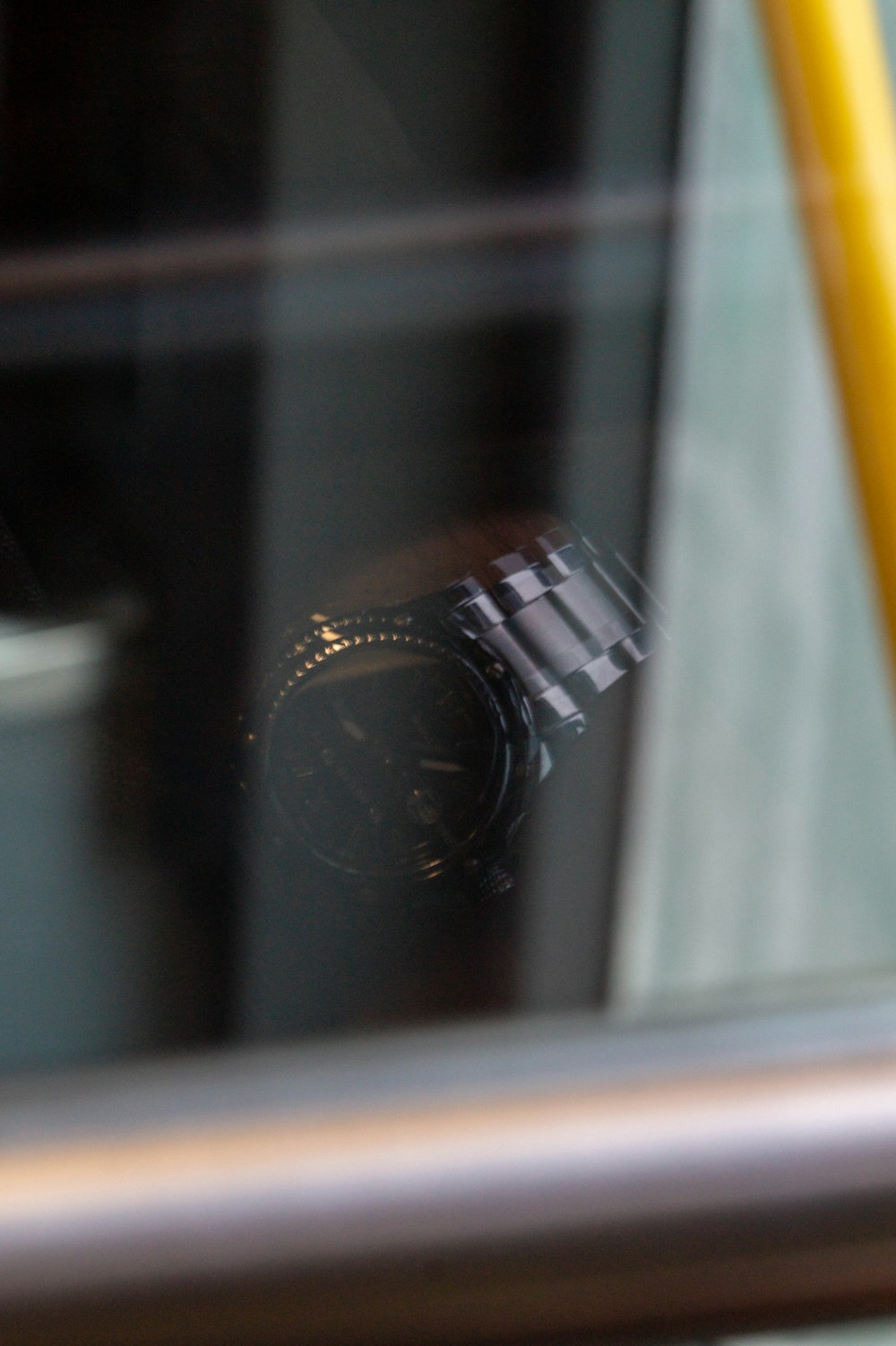 a camera is seen through a window of a bus
