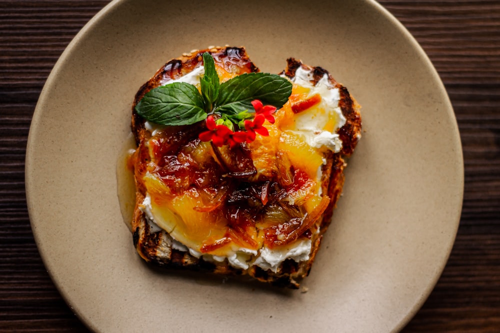 a piece of toast topped with fruit and whipped cream