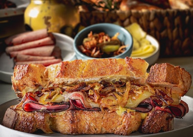 A hearty roast beef sandwich with caramelized onions and melted Swiss cheese on a toasted baguette.