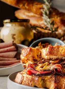 A close-up of a gourmet sandwich filled with fresh vegetables and meats.