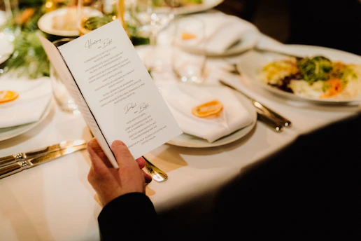 a person sitting at a table with a menu
