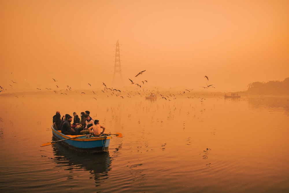 a group of people in a small boat on a lake