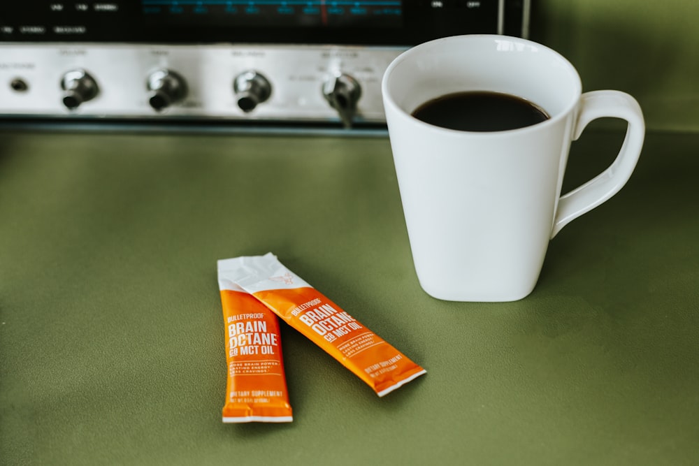 a cup of coffee next to two bars of chocolate