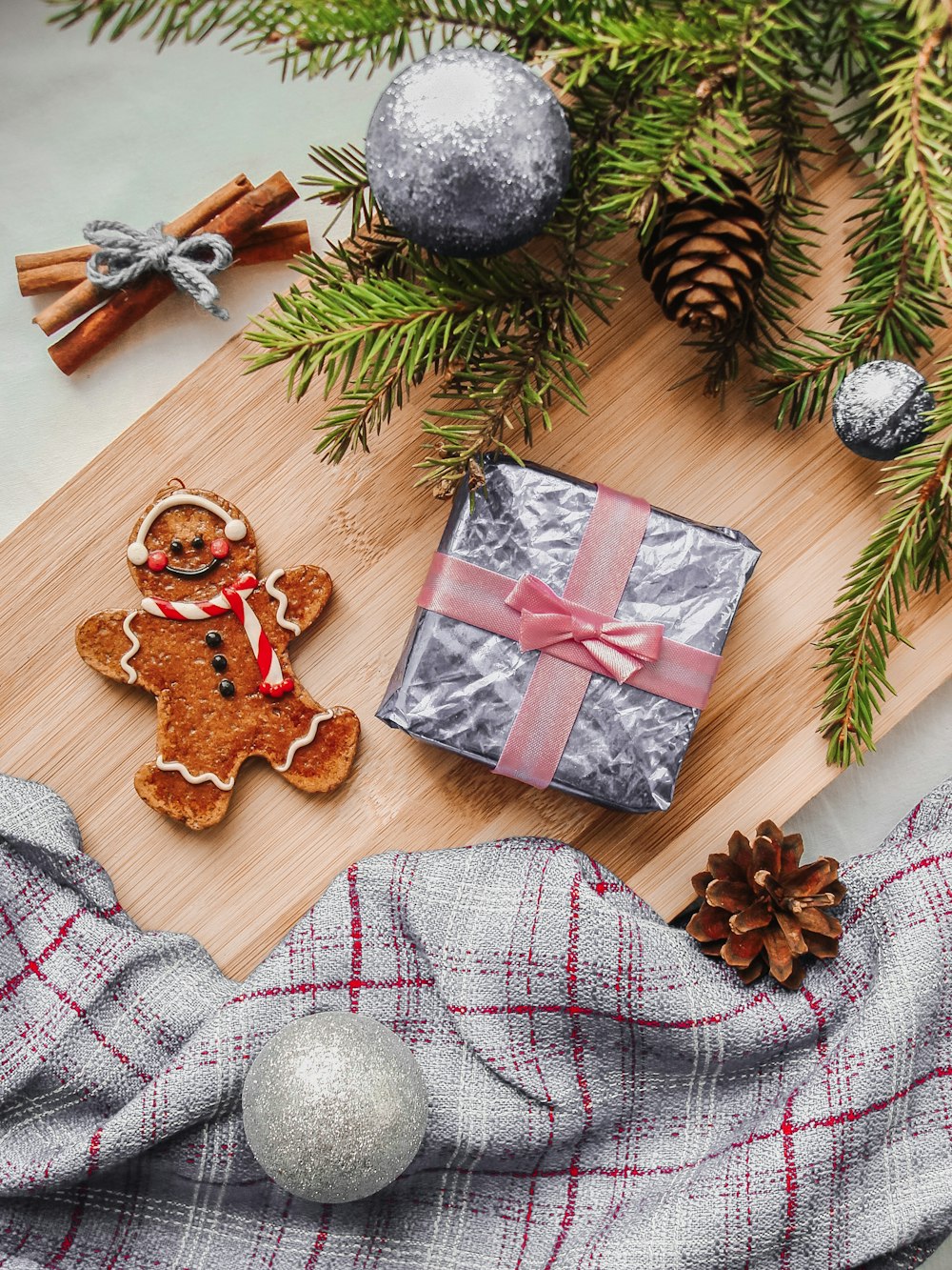 a wooden cutting board topped with christmas decorations