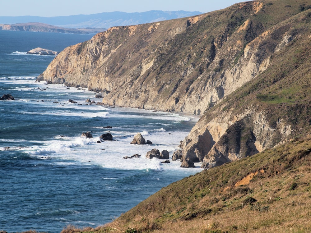 a view of the ocean from the top of a hill