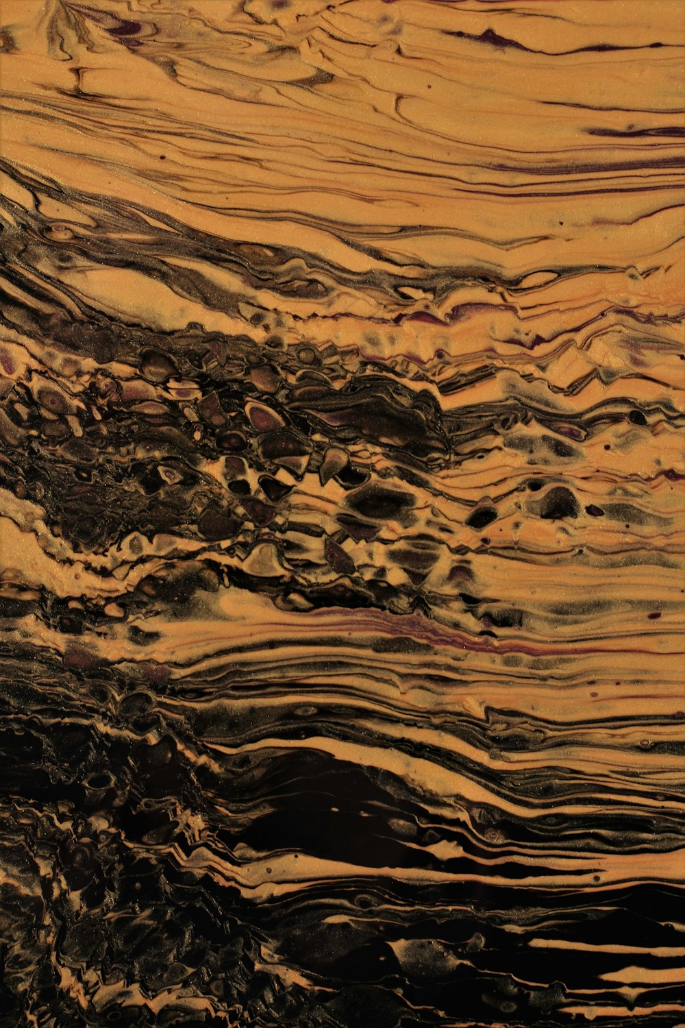 a close up of a brown and black marble