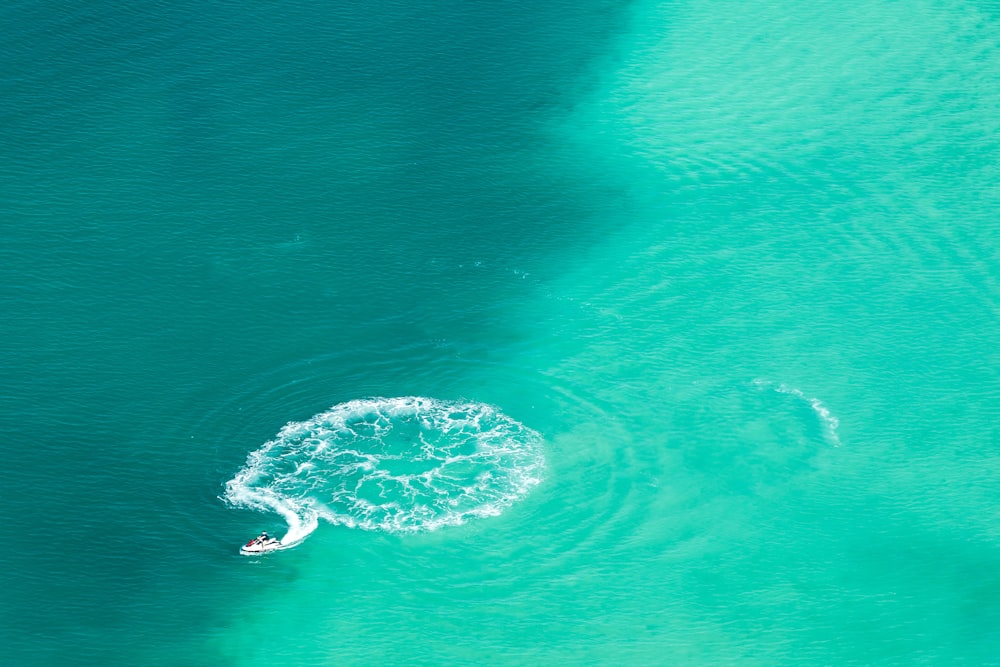 a person riding a surfboard on a wave in the ocean