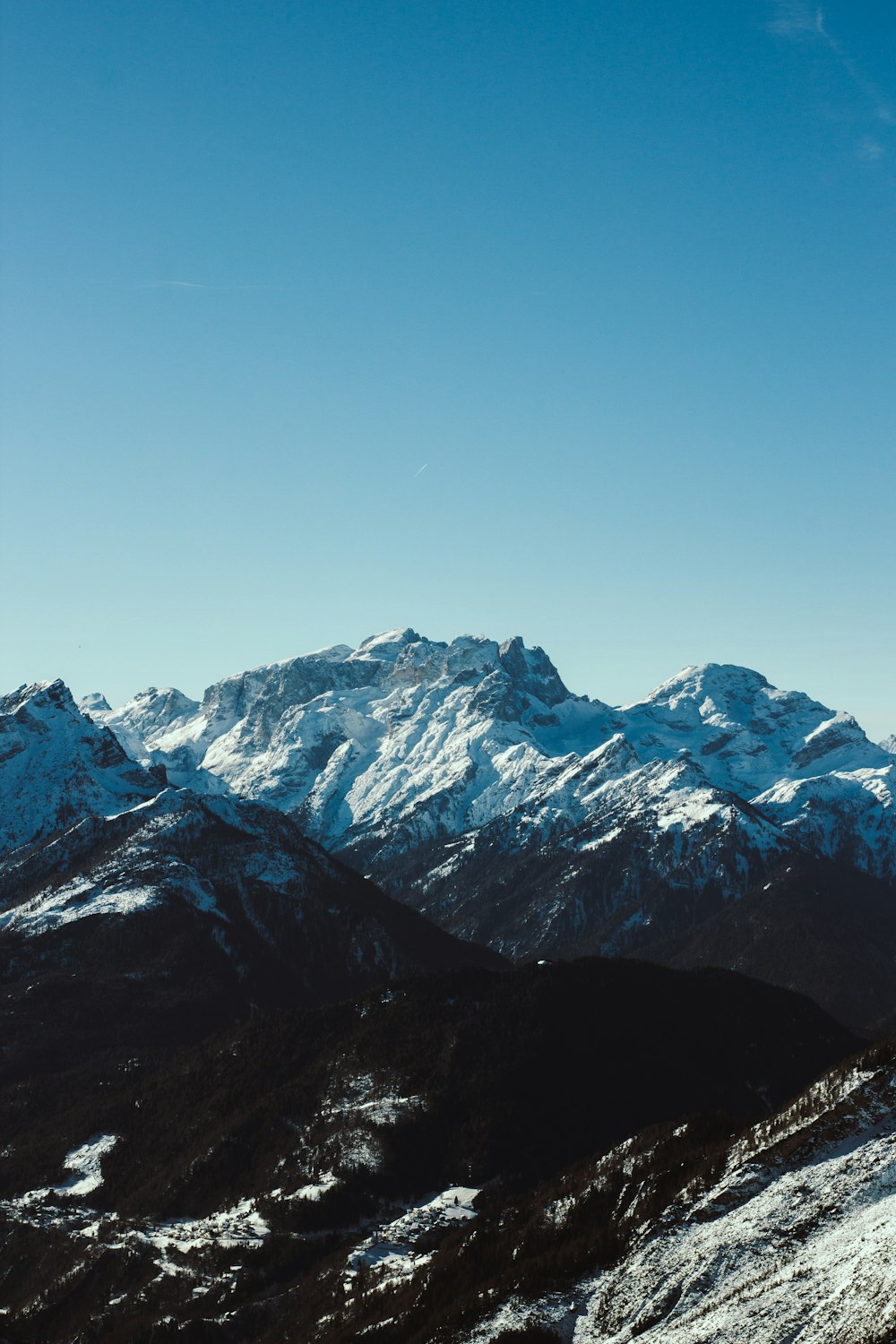 a person standing on top of a snow covered mountain