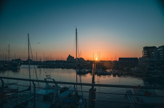 a harbor filled with lots of boats at sunset