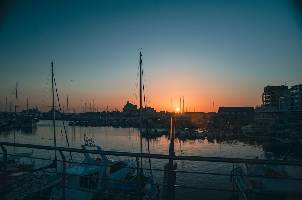 a harbor filled with lots of boats at sunset