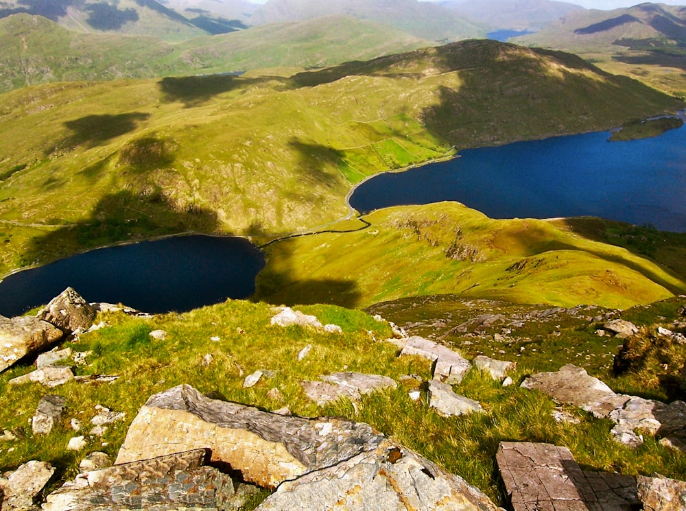 a view of the mountains and lakes from the top of a hill