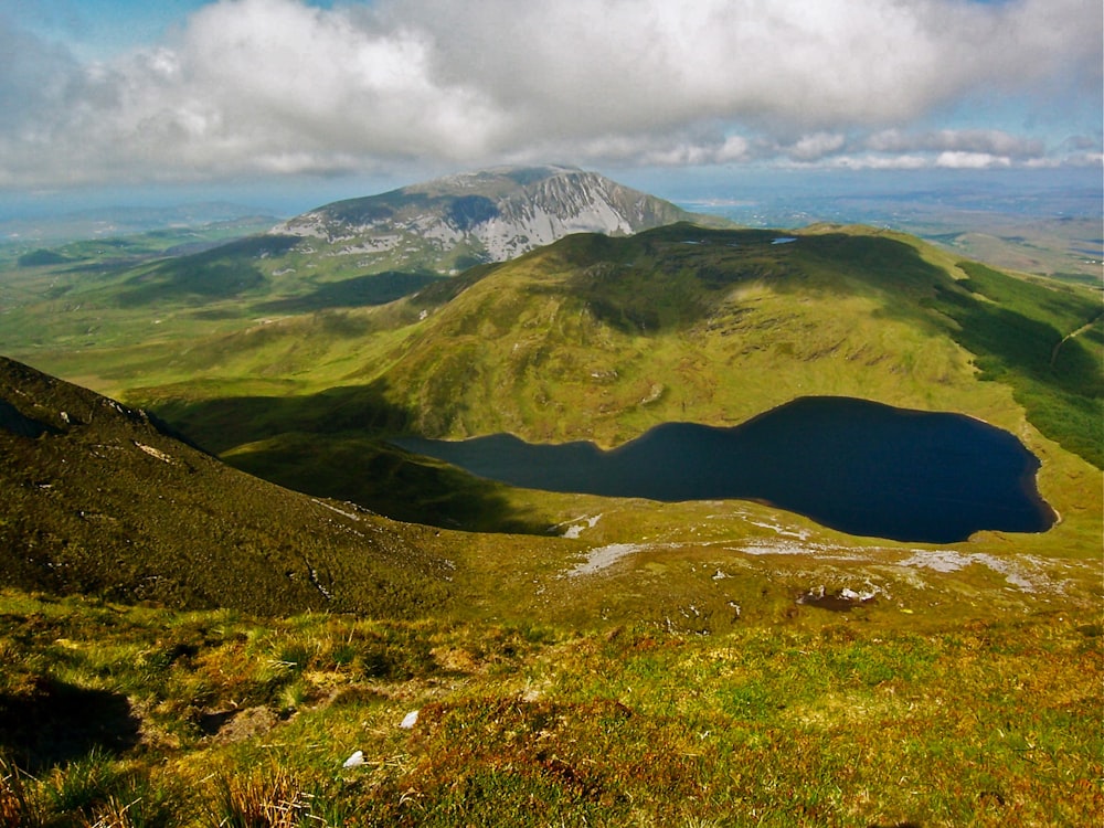 a view of a mountain range with a lake in the foreground