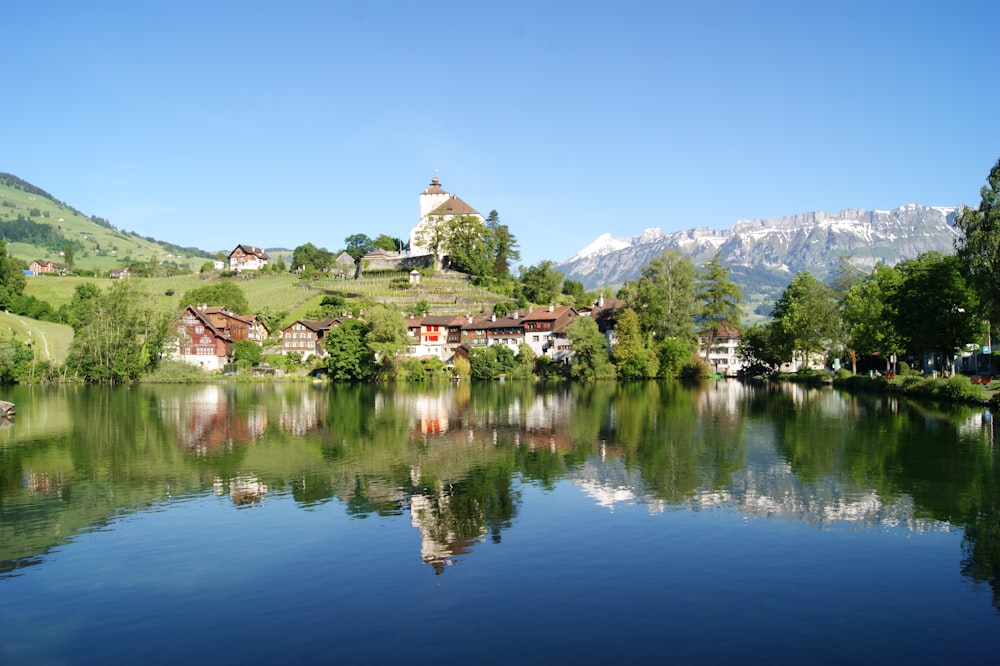 a lake surrounded by mountains and houses