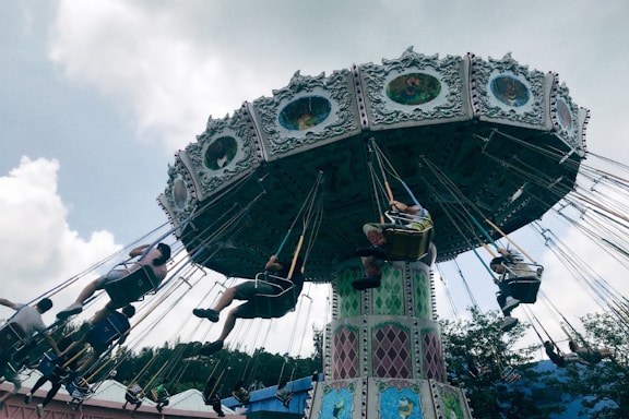 a group of people riding on top of a merry go round