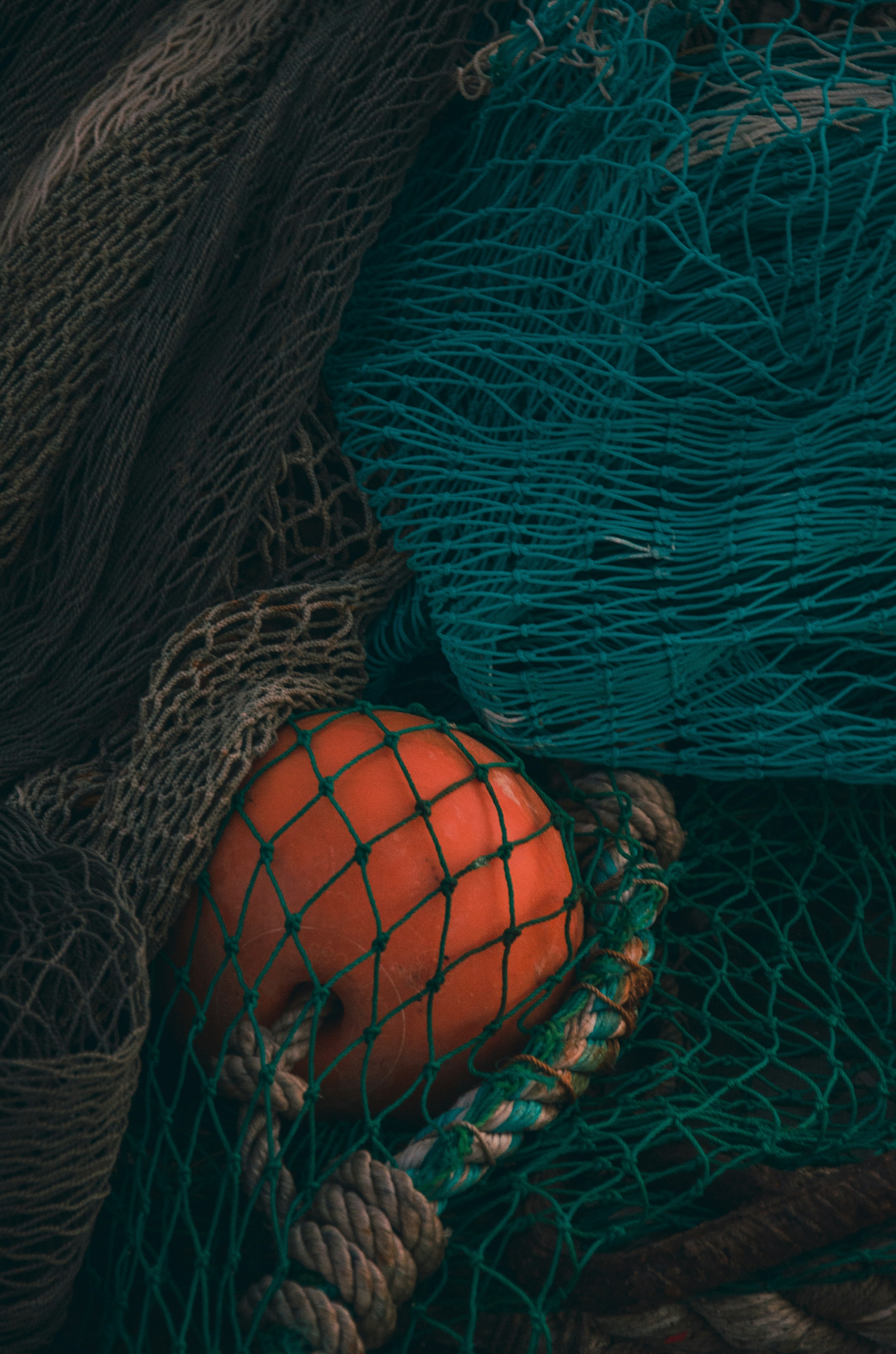 a pile of fishing nets with an orange in it