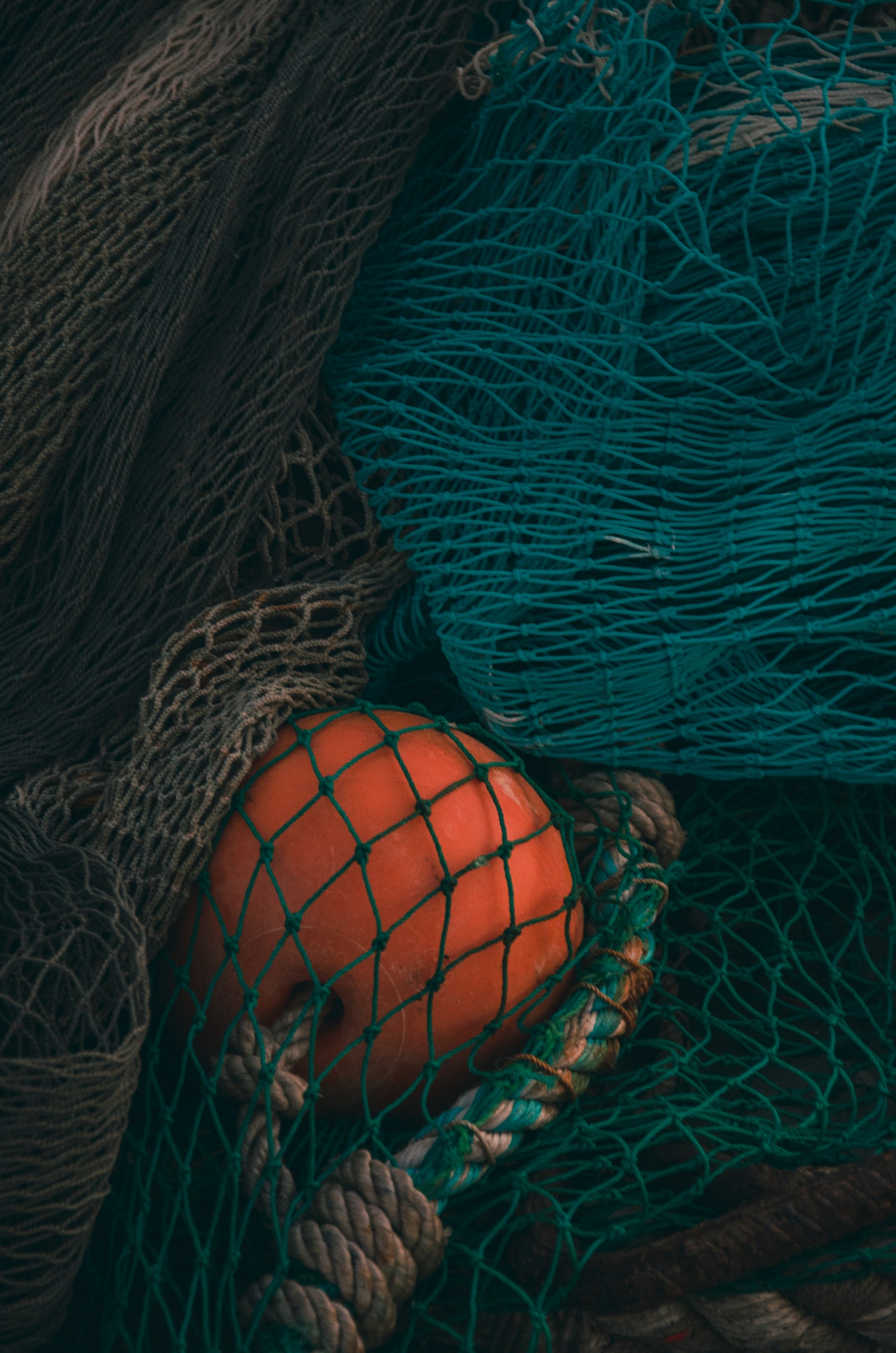 a pile of fishing nets with an orange in it