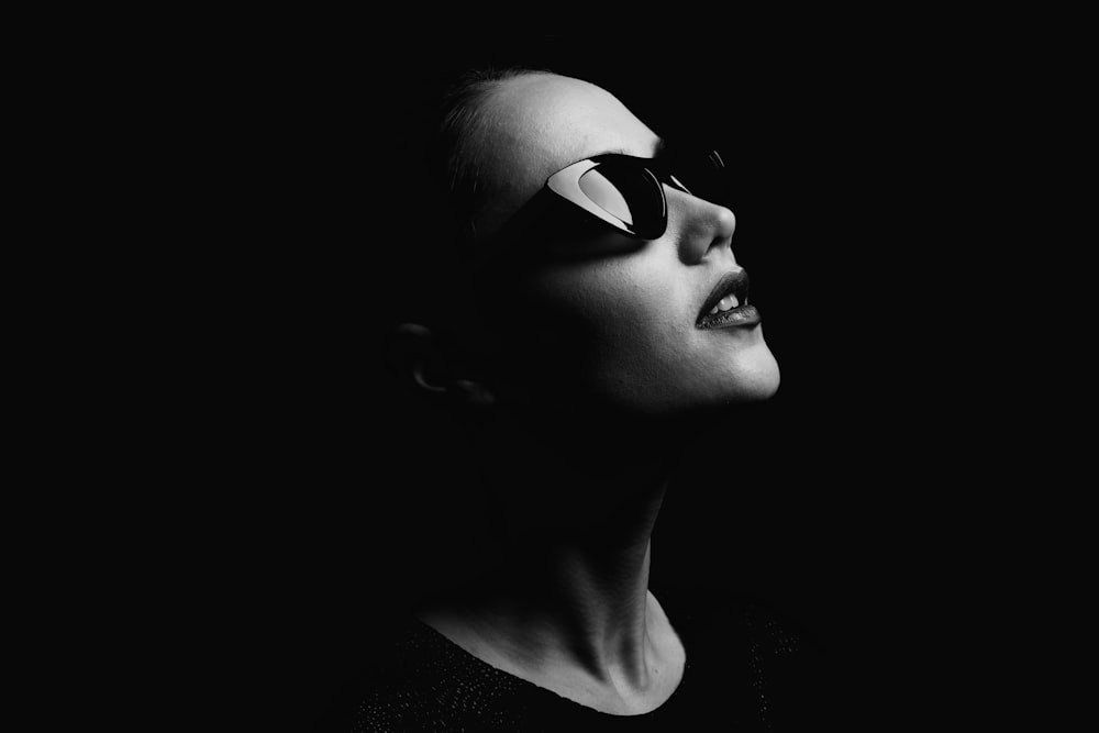 a woman wearing sunglasses and a black shirt