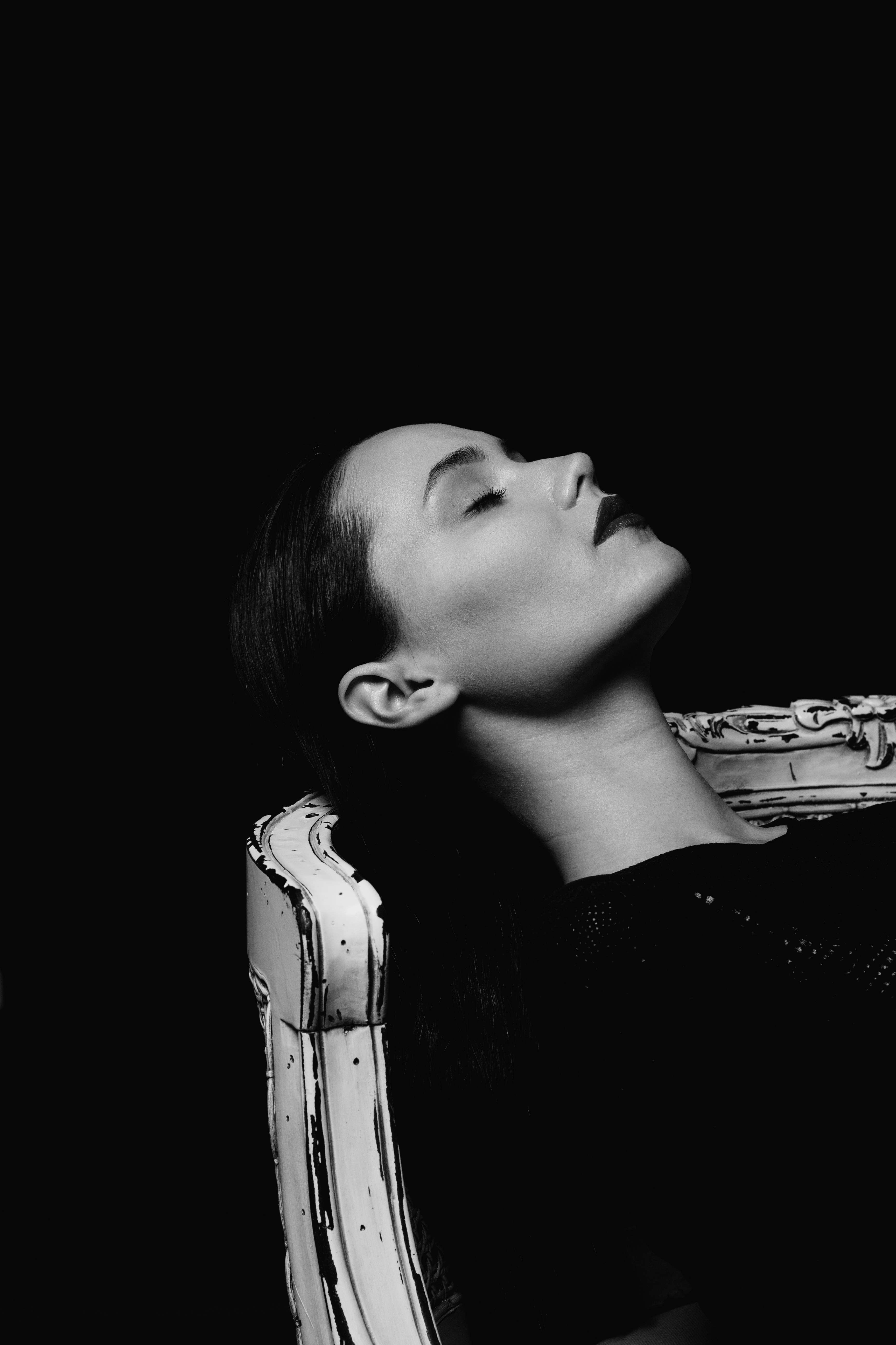 A woman sitting in a chair with her eyes closed photo – Free Female ...